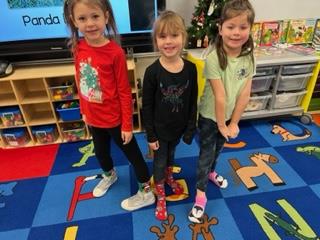 Children wearing their Christmas socks